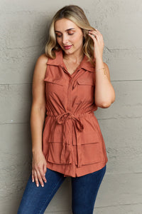 The Light Sleeveless Collared Button Down Top